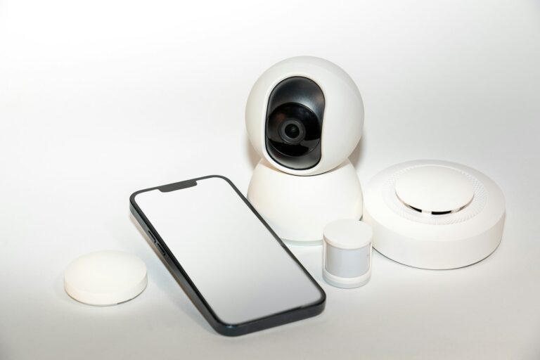 Smartphone next to a CCTV security camera for remote viewing