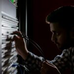 Network engineer working on a server rack